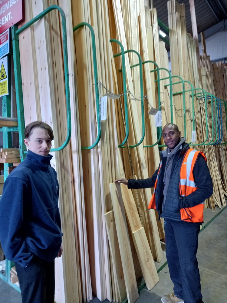 pupil measures timber sheets with Dan