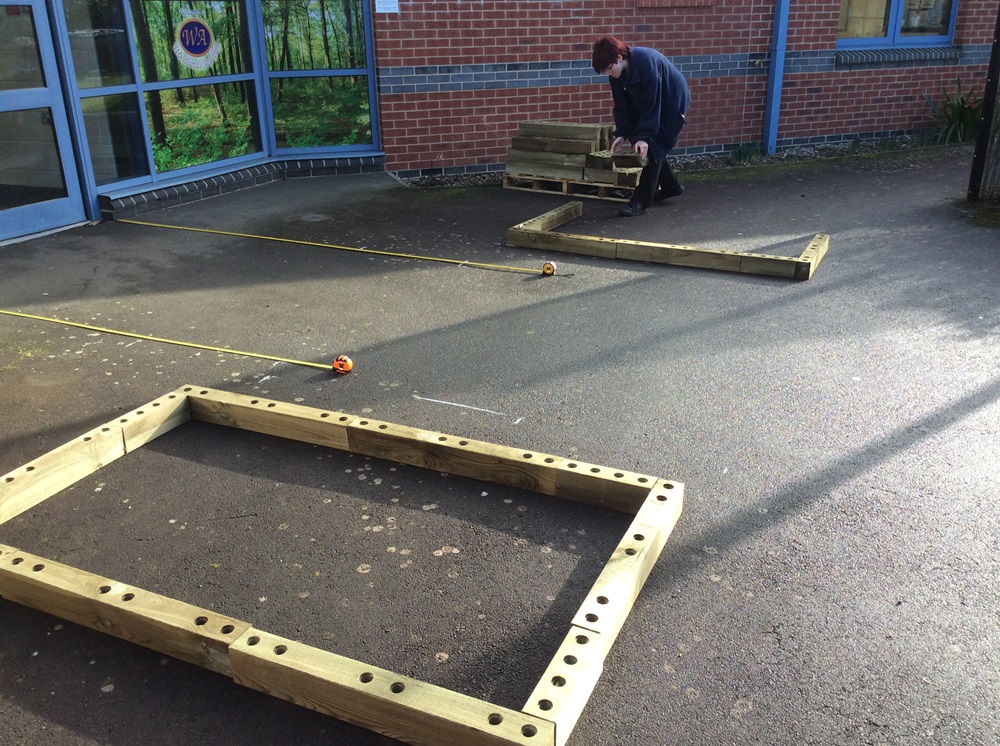 Pupils lay out planter sizes on the ground