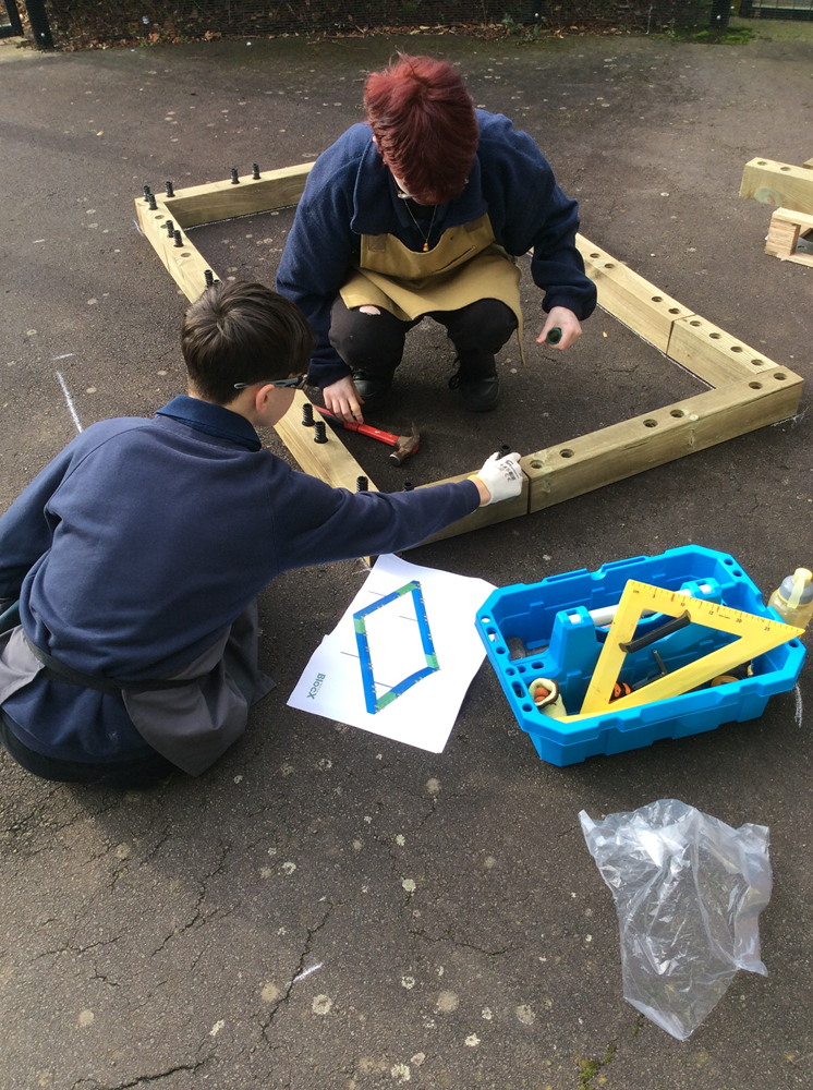 Pupils measuring to build their new planters