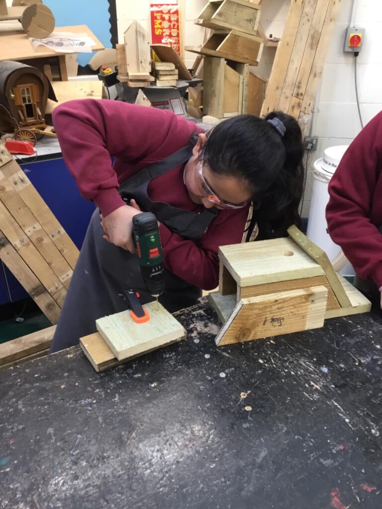 a pupil tried the drill to join two pieces of wood together